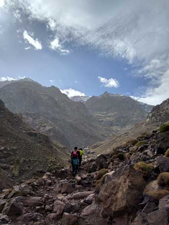 people walking up a steep mountain