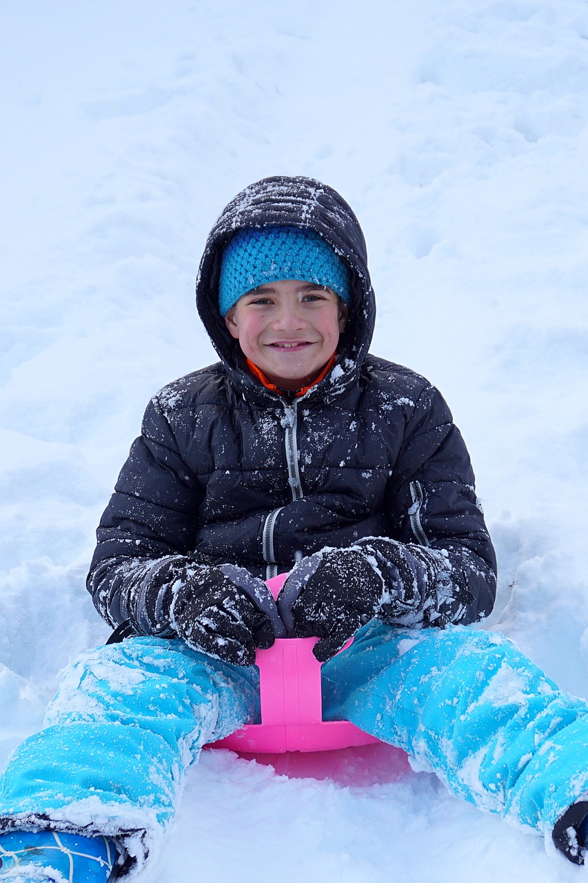 boy on sledge - insulated clothing